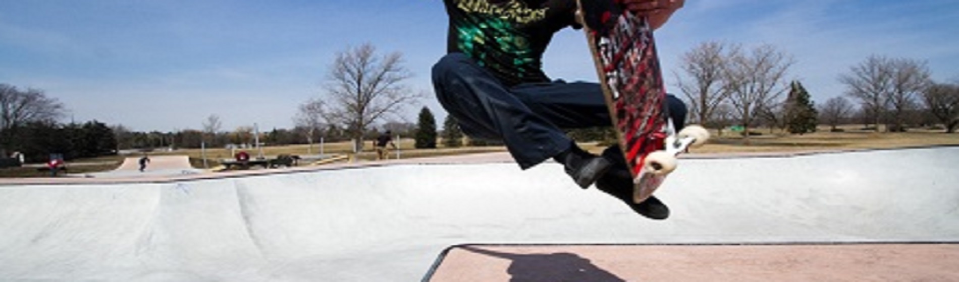 cropped image of skateboarder going aerial at skate park