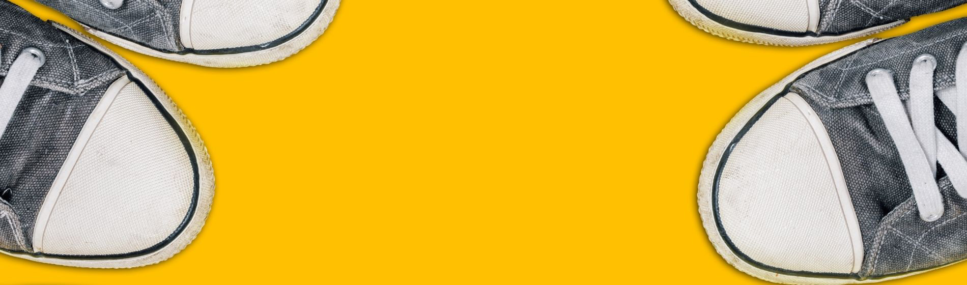 running shoe toes on golden background