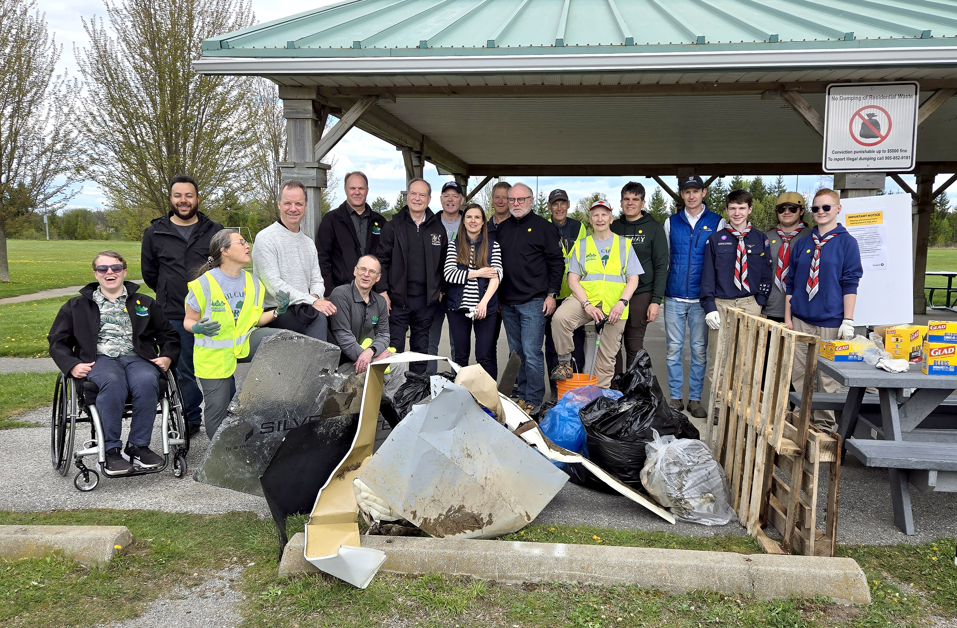 group of attendees behind collection of trash