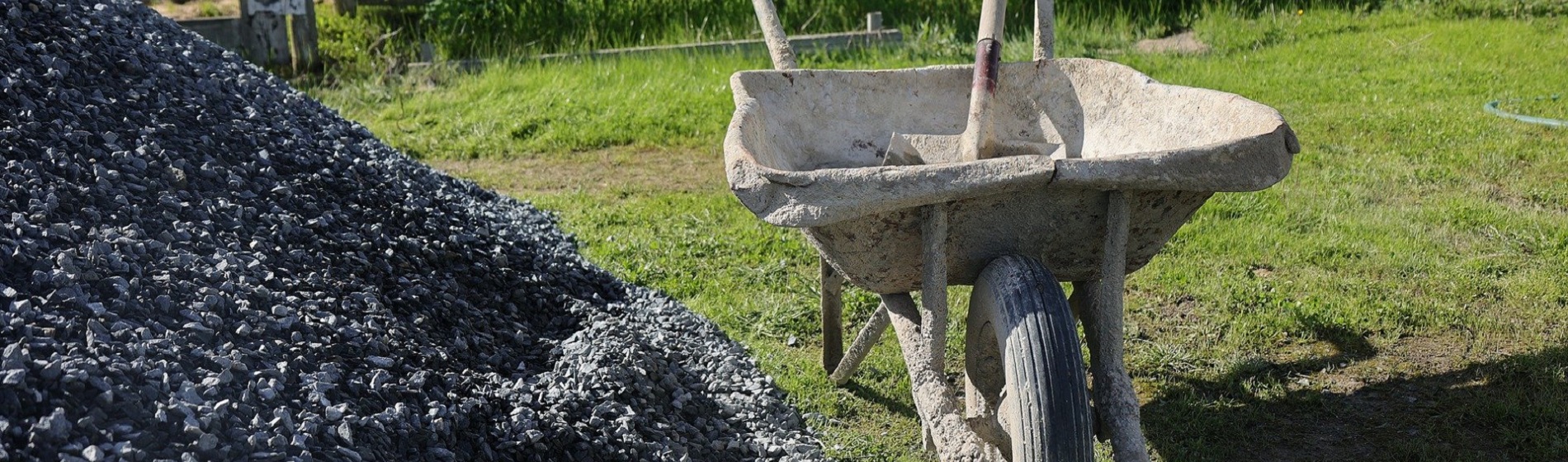 wheelbarrow beside gravel pile