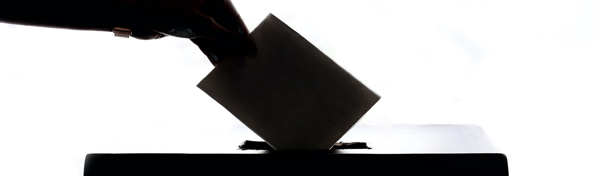 hand dropping ballot into ballot box